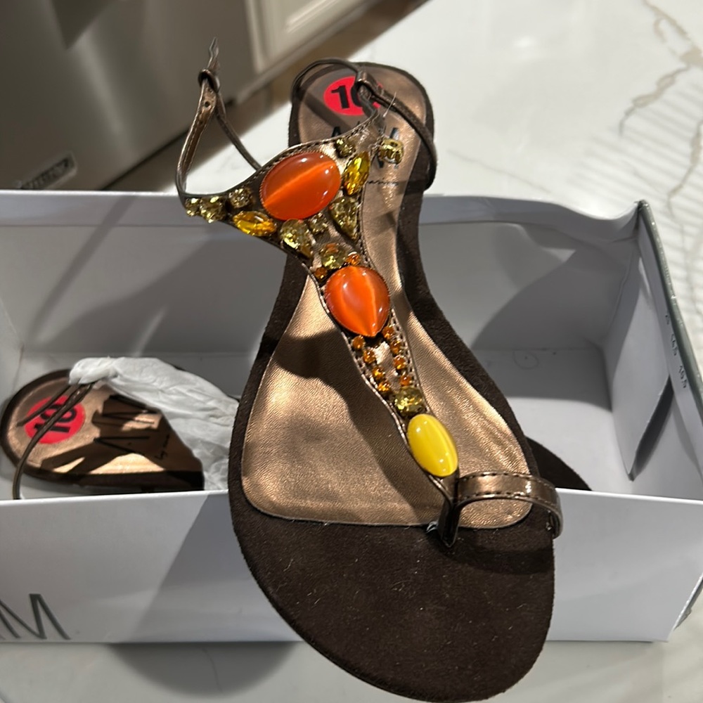 Brown suede n jewel sandals stone is loose on right foot as seen in photo.
